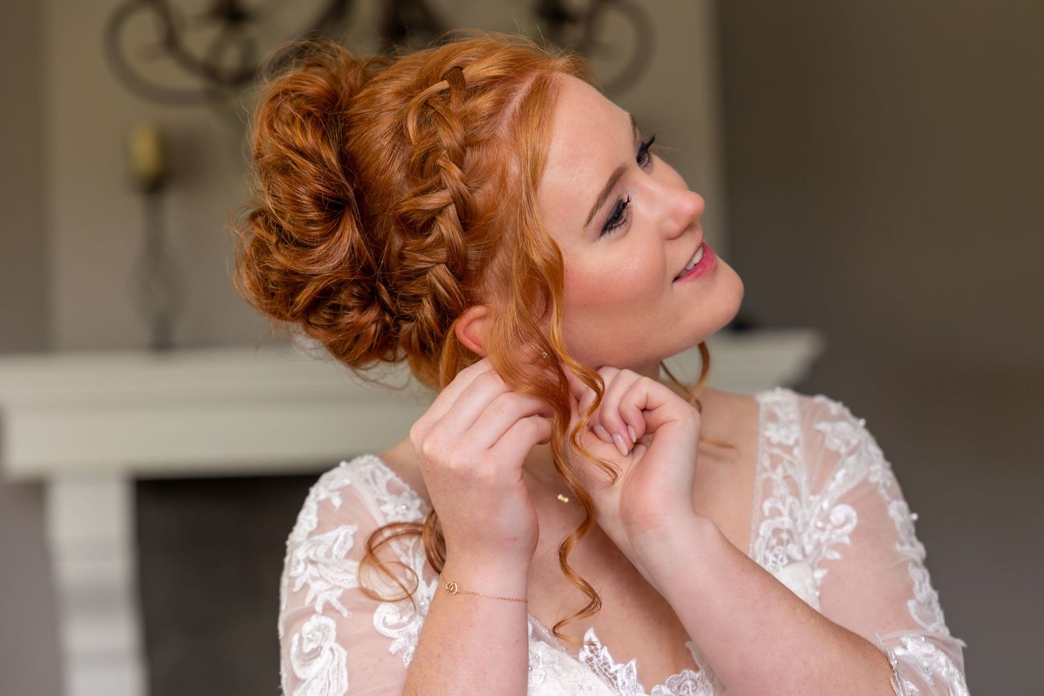 An elegant updo hairstyle with delicate lace wedding dress details.