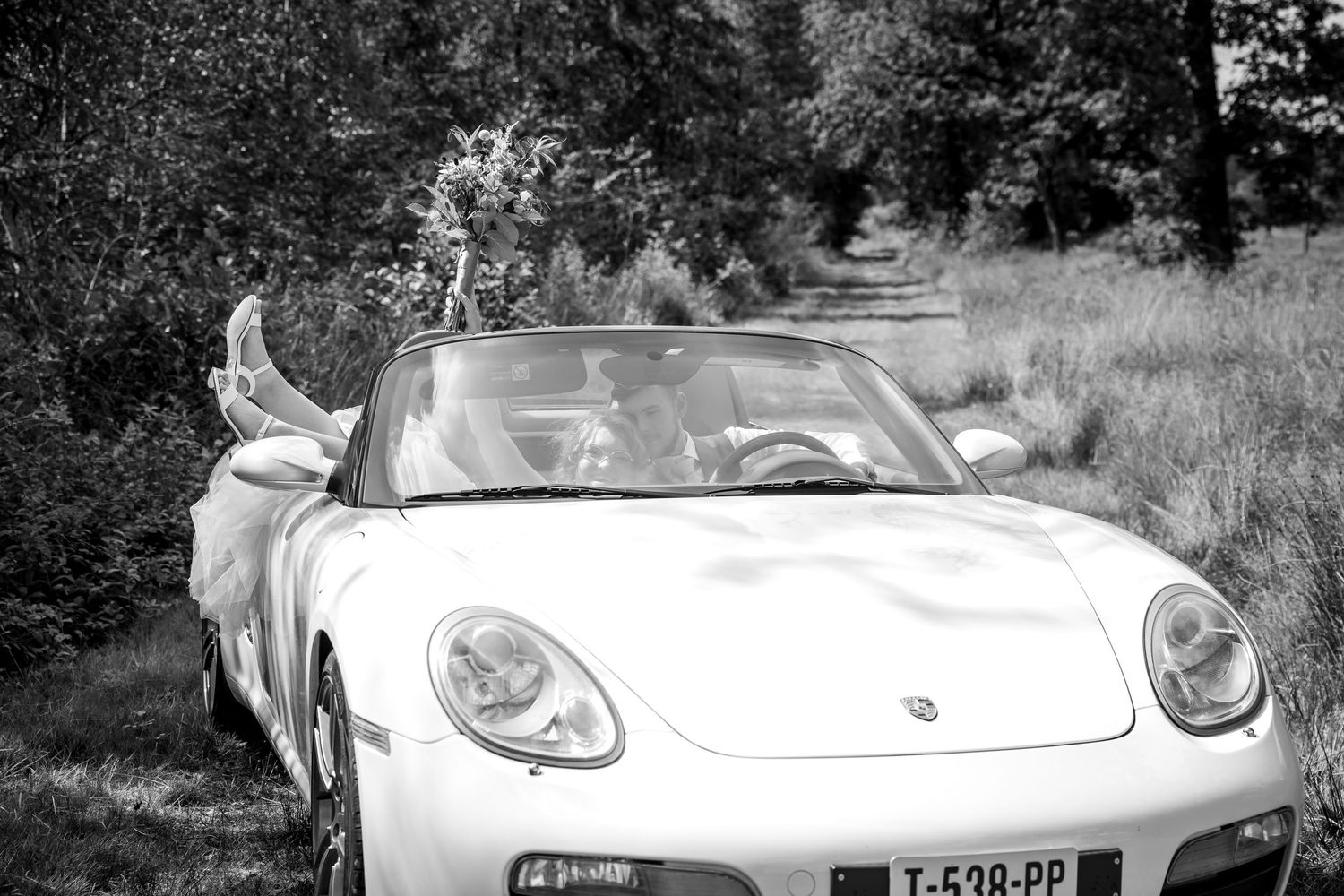 Black and white photo series featuring vintage car and wedding portraits in natural setting.
