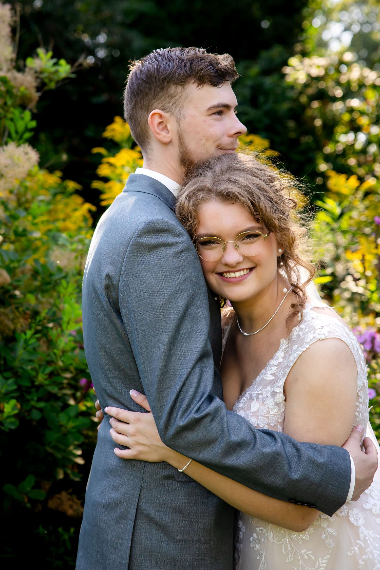 A tender embrace captured in a garden setting with autumn colors.