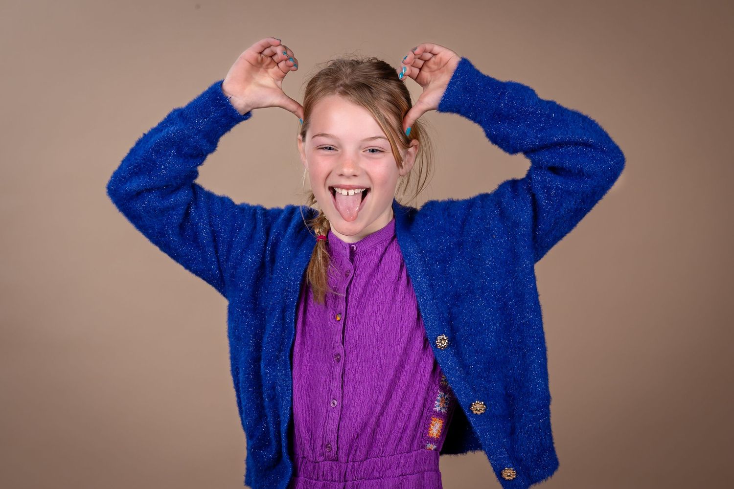 A series of five expressive photos showing a person in a blue jacket and purple shirt against a neutral background.