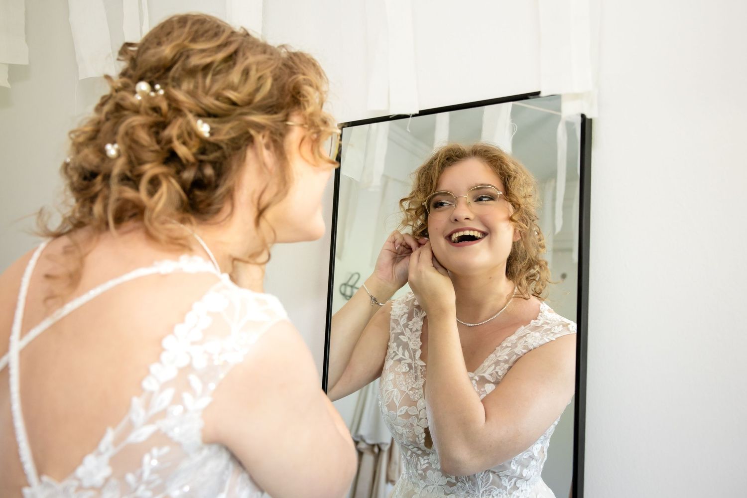 Getting ready sequence showing final touches being made to a bridal look.