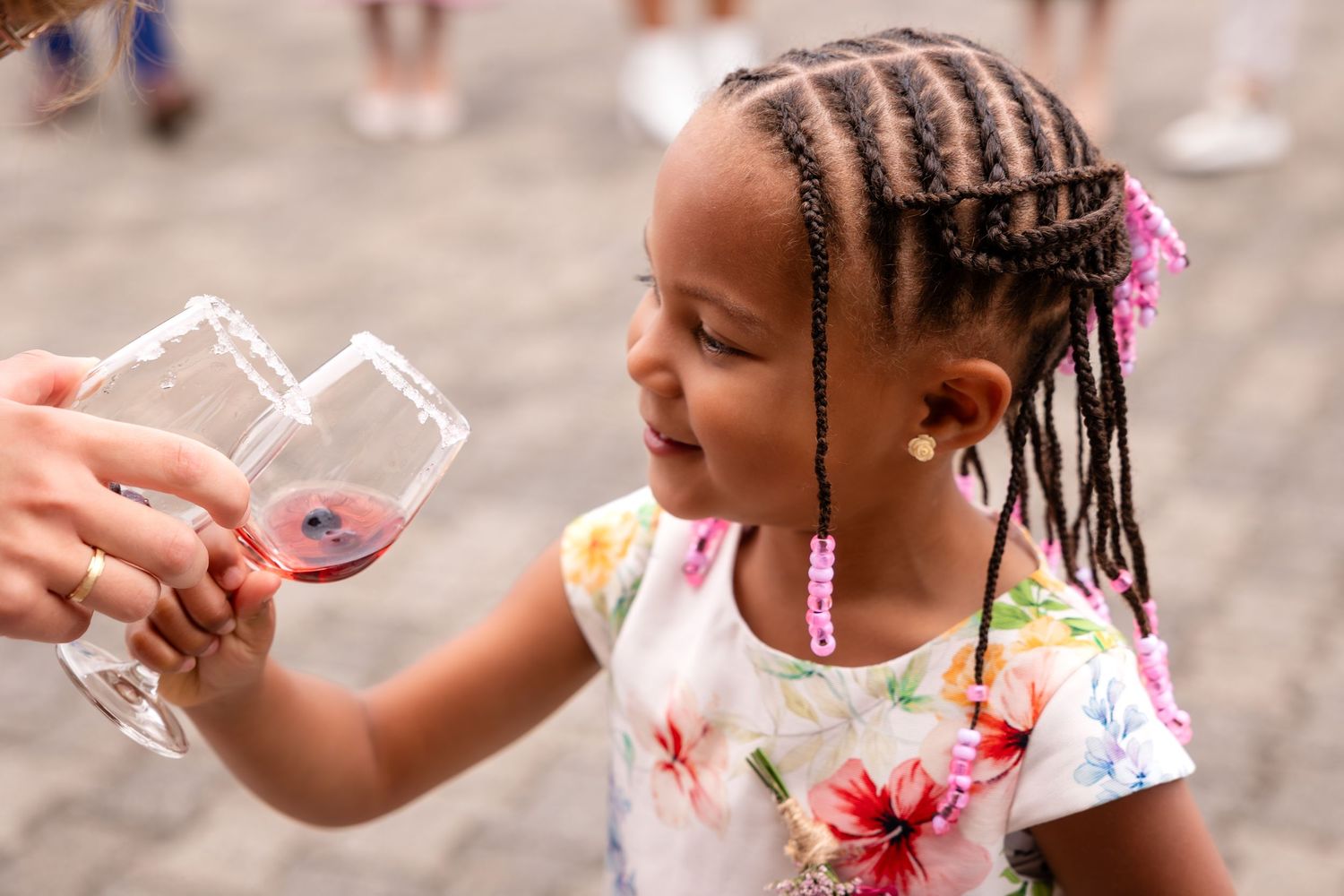 Children blowing bubbles during an outdoor wedding celebration.