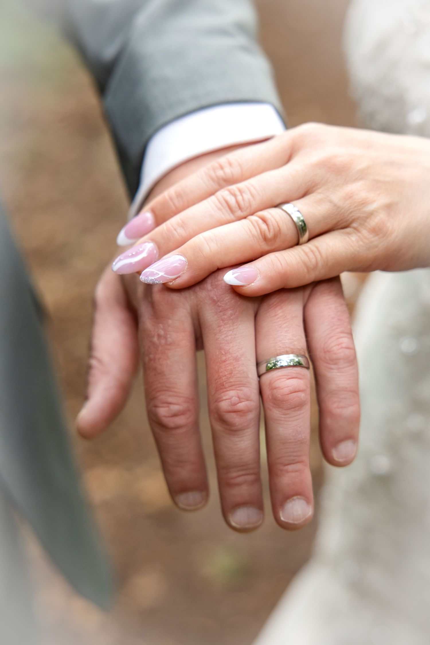 Close-up series of hands with wedding rings showing gentle touching and holding gestures against a blurred background.