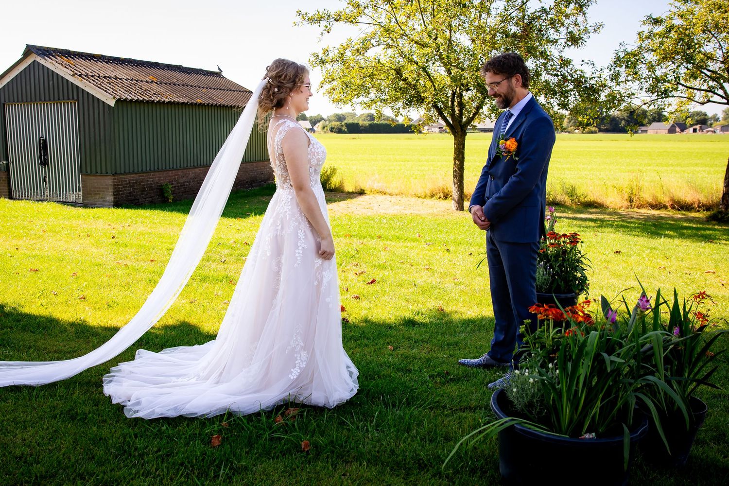 Wedding couple's first look moment captured in a serene garden setting.