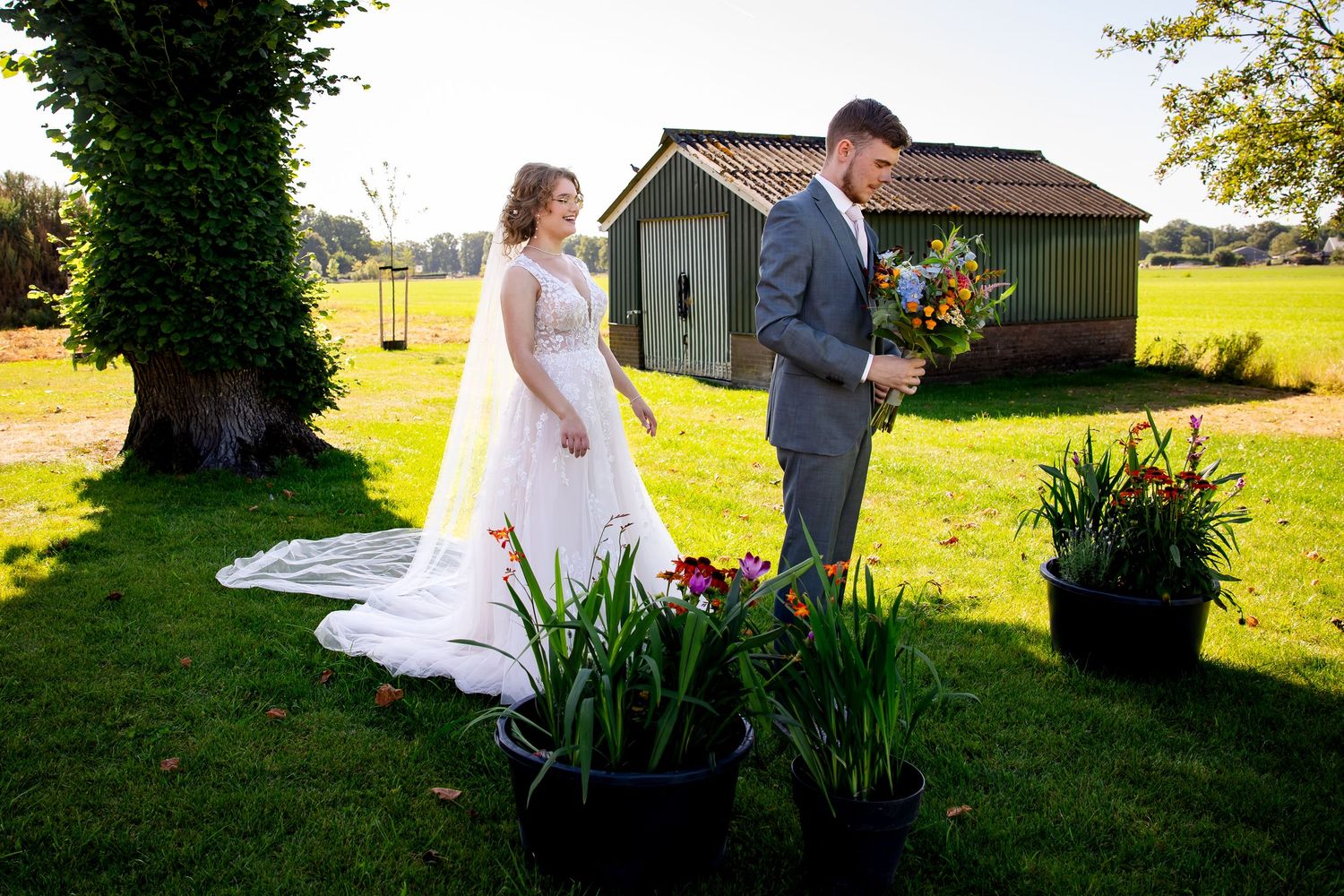 Wedding couple's emotional first meeting captured in golden afternoon light.