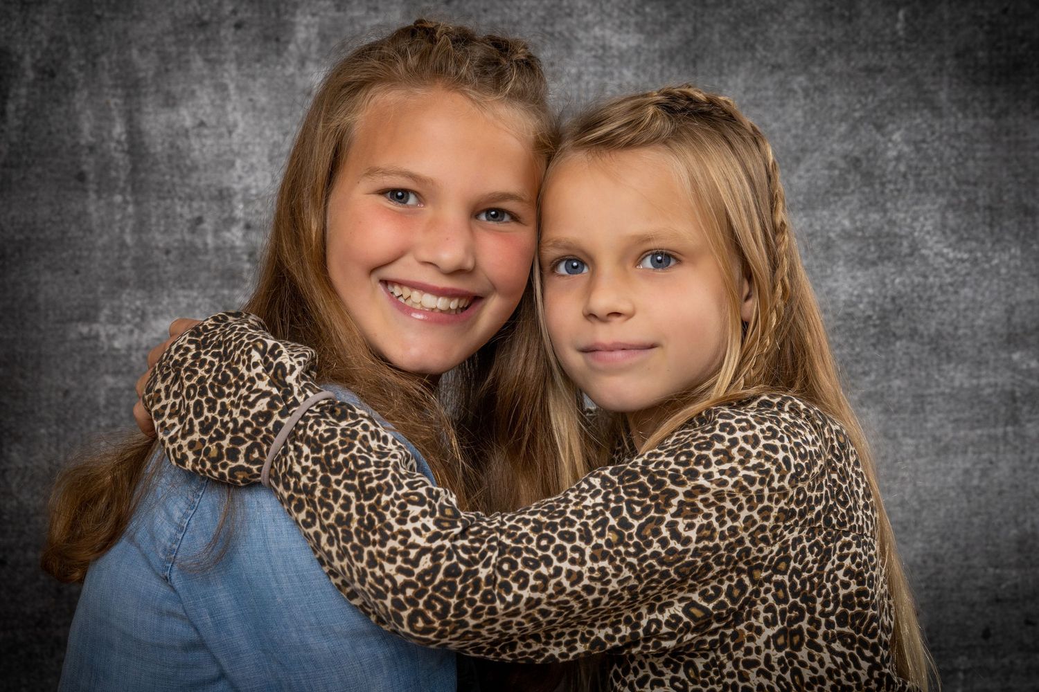 A series of black and white portraits showing loving family moments and expressions against a textured background.