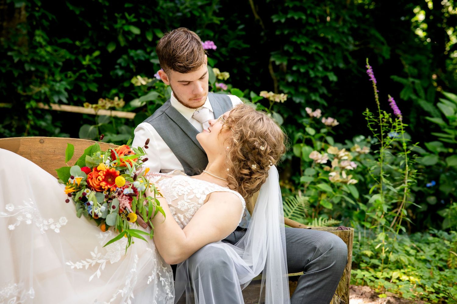 Romantic garden wedding portraits with colorful floral bouquet.