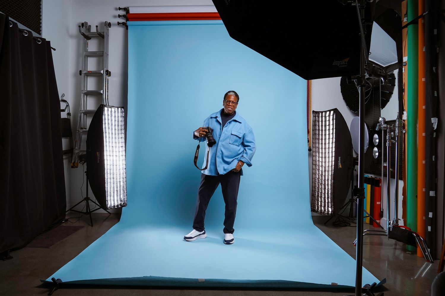 Professional photo studio setup showing light stands, backdrops, and equipment arranged in sequence.