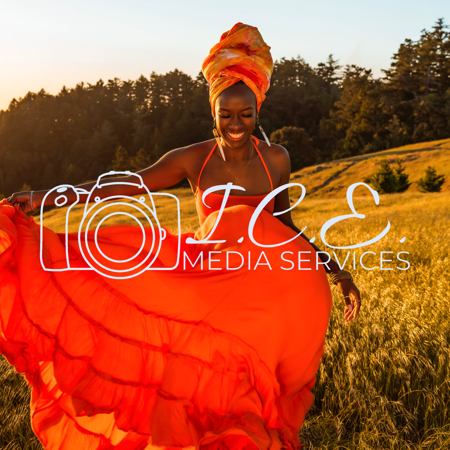 Vibrant outdoor portrait with ICE Media Services logo featuring flowing orange fabric against sunset.