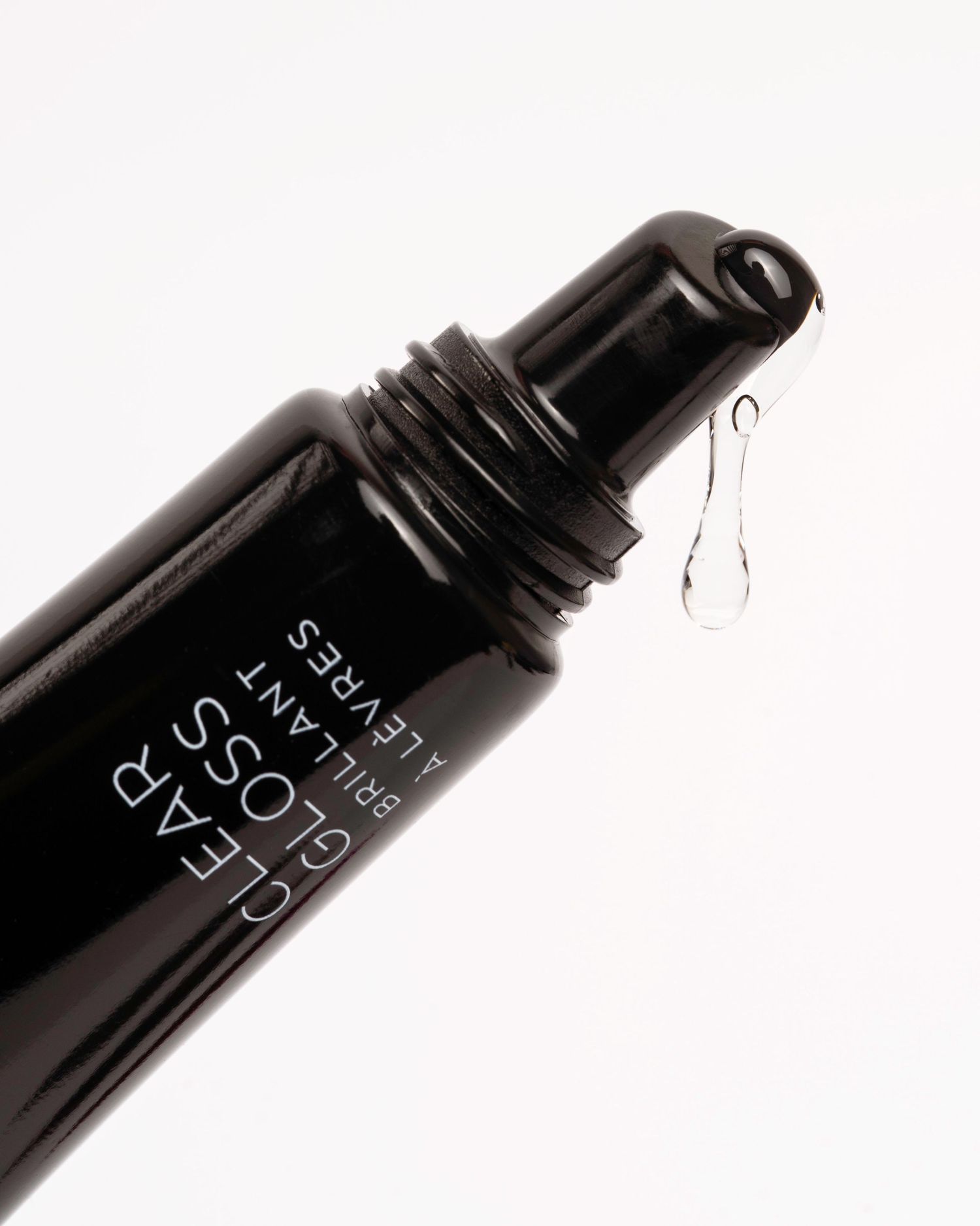 Close-up macro shot of black cosmetic product packaging.