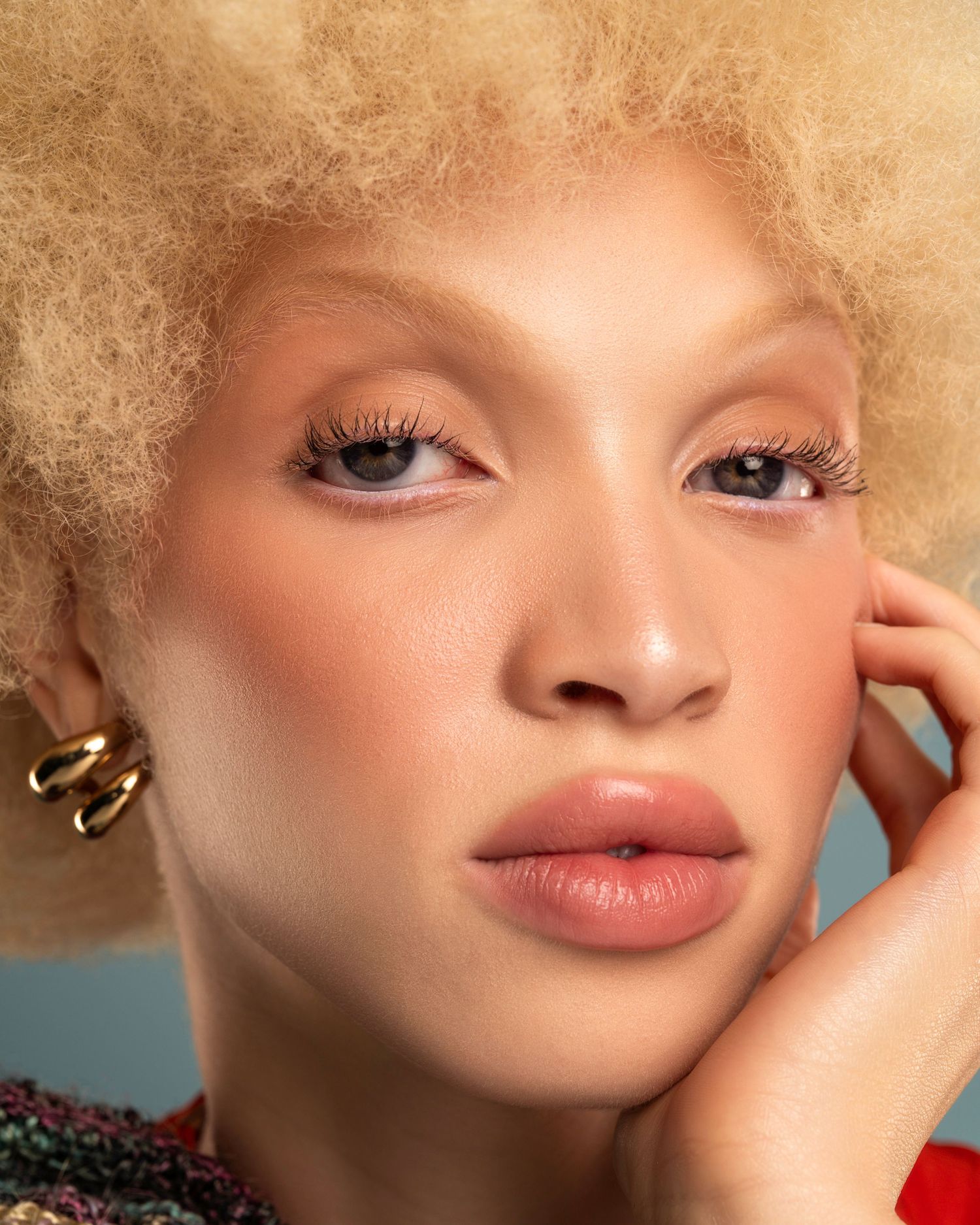 Beauty portrait series featuring soft lighting and natural makeup against warm background.