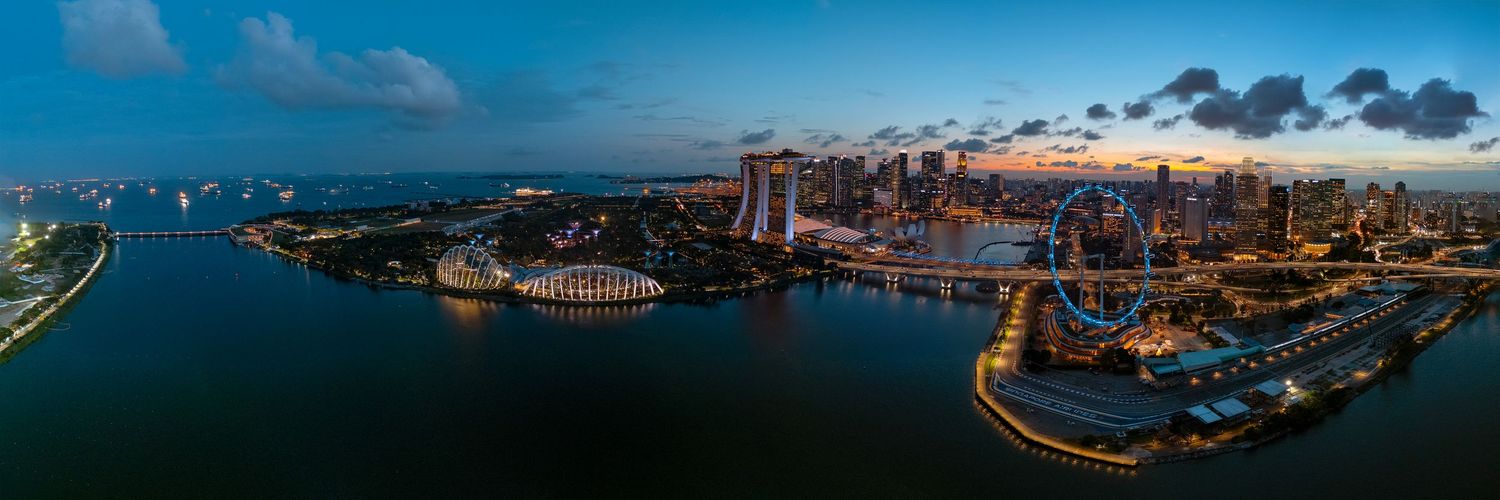 Panoramic cityscape view of a coastal metropolis with modern buildings and waterfront.