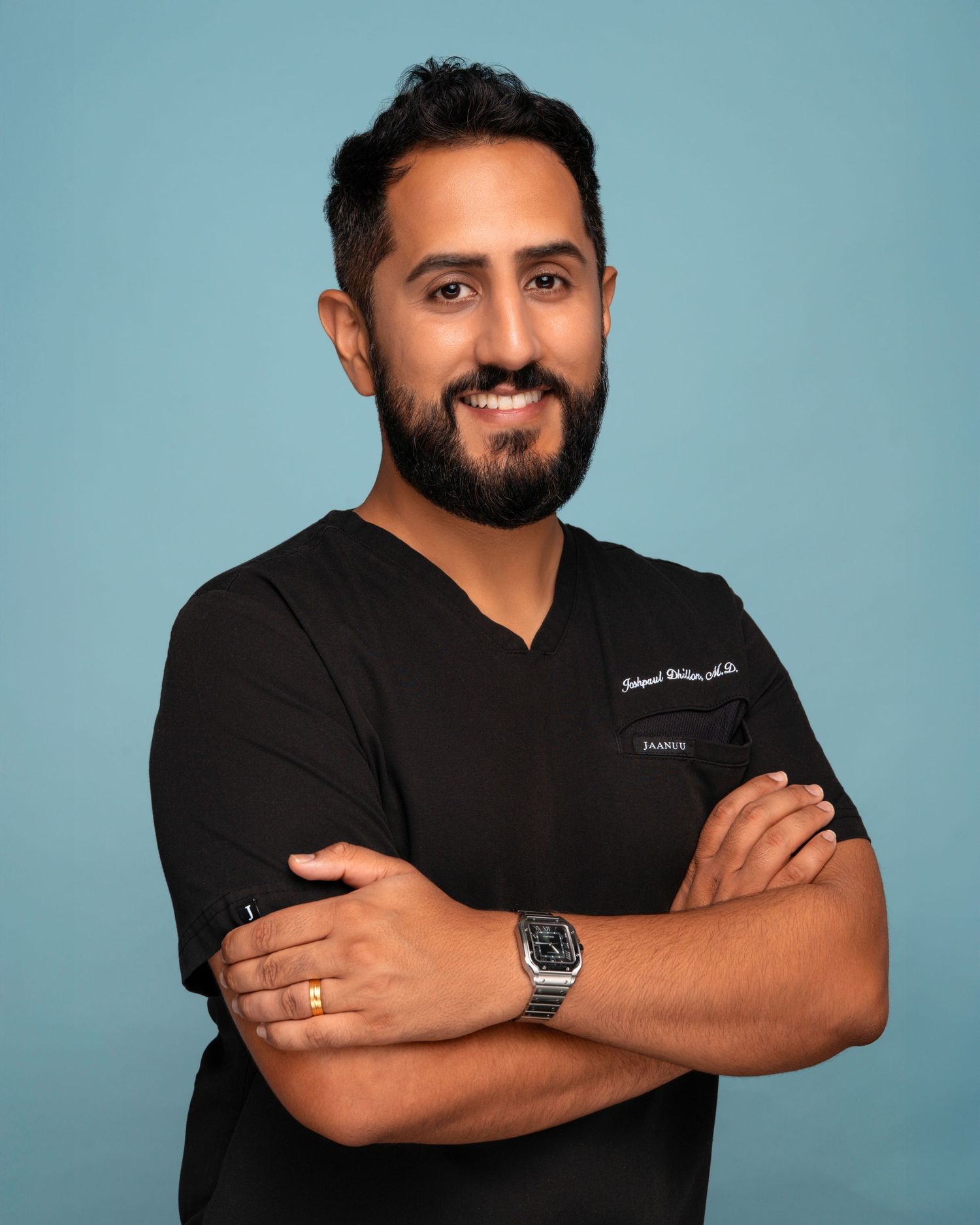 Professional headshots of a medical professional in a black shirt against a blue background.