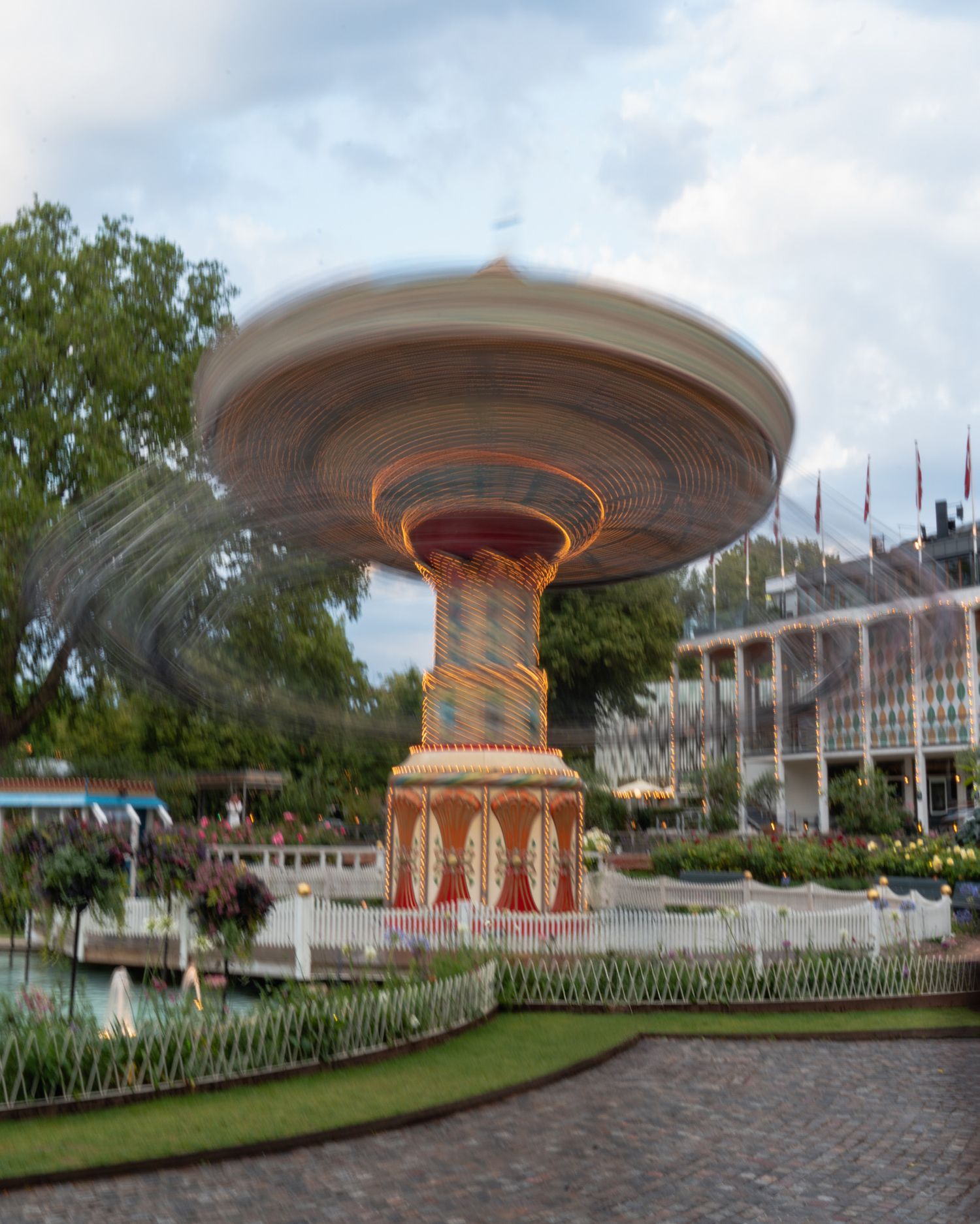 Vintage carousel and amusement rides in a traditional theme park setting.