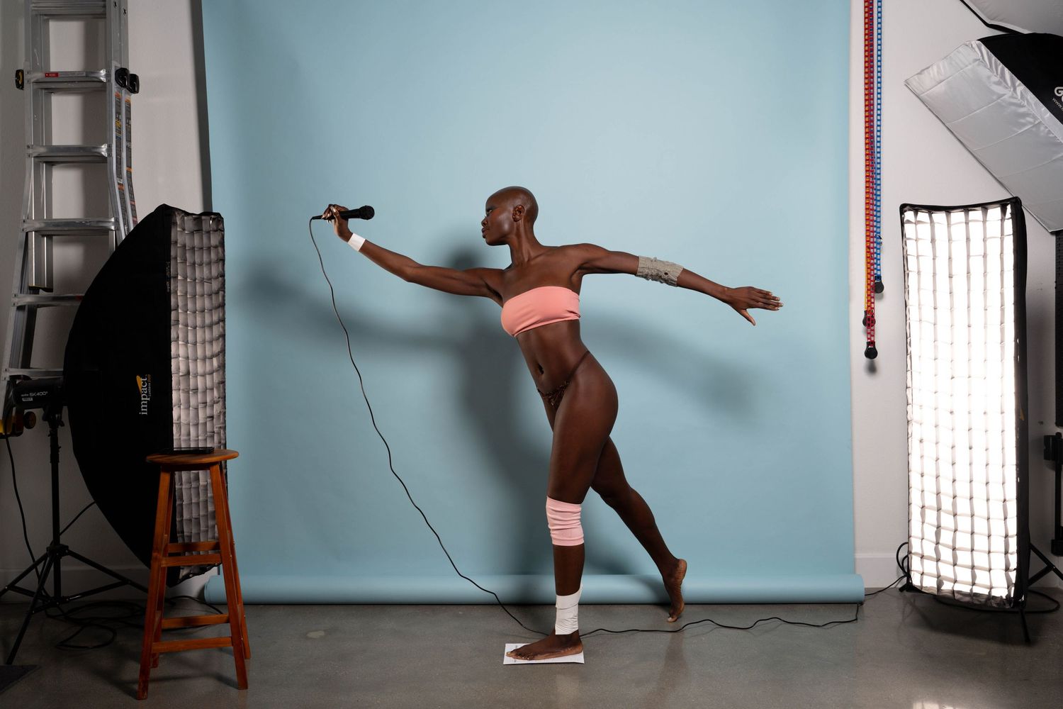 Contemporary dance movements captured in sequence against light blue studio wall.
