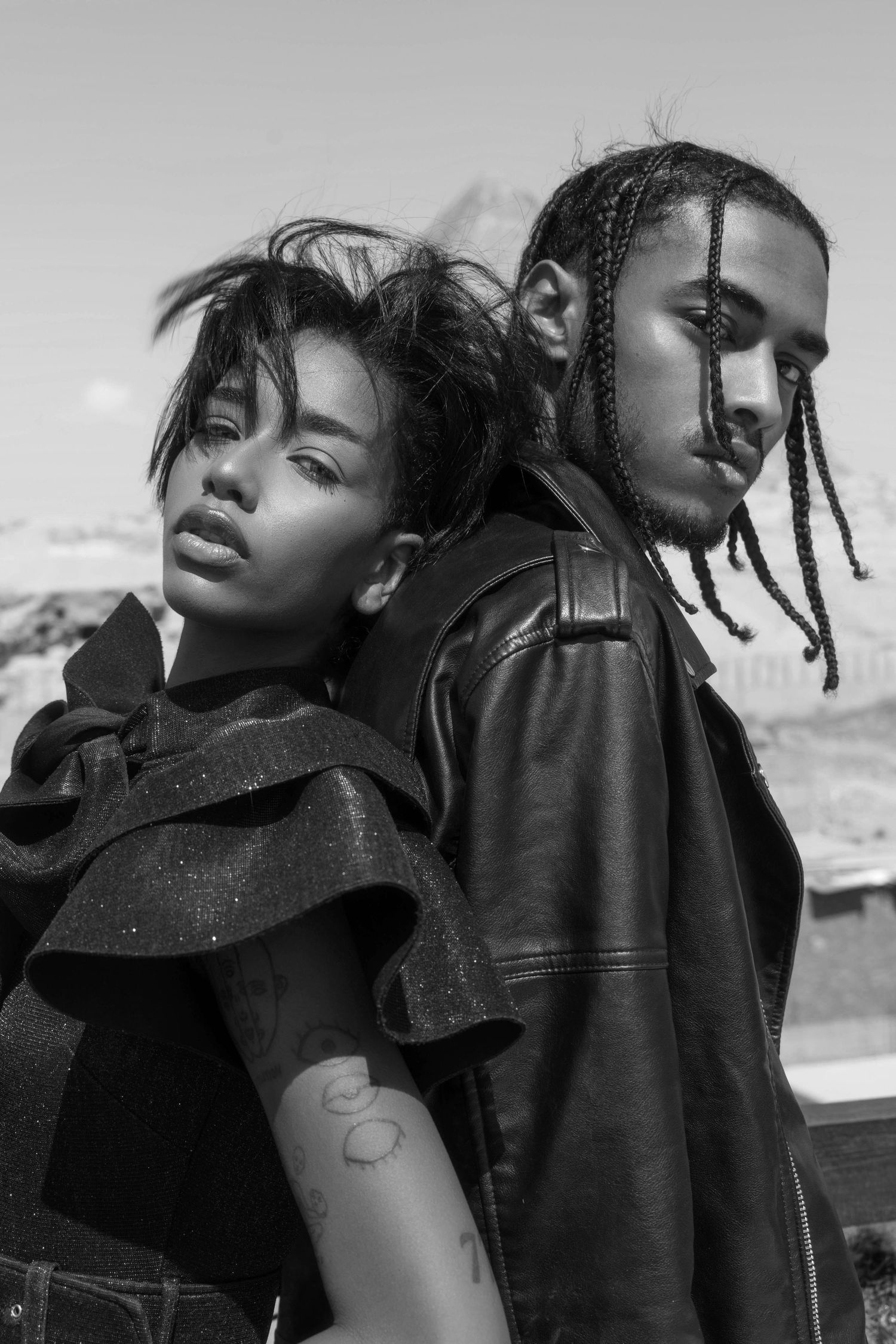 Artistic black and white fashion portraits showing dynamic poses and interactions.