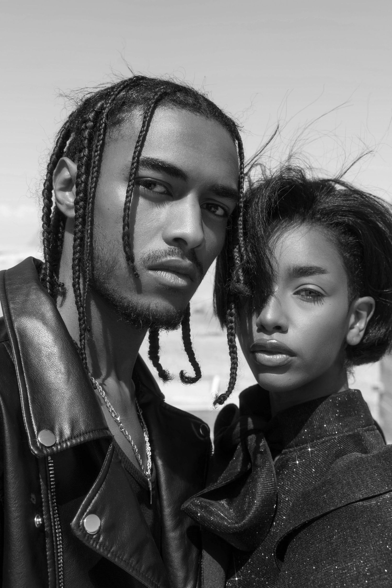 Black and white fashion portrait with dramatic lighting and styling.