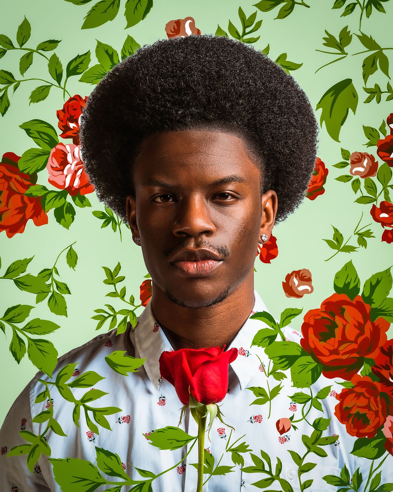 Portrait against floral wallpaper with red roses and green leaves creating an elegant garden backdrop.