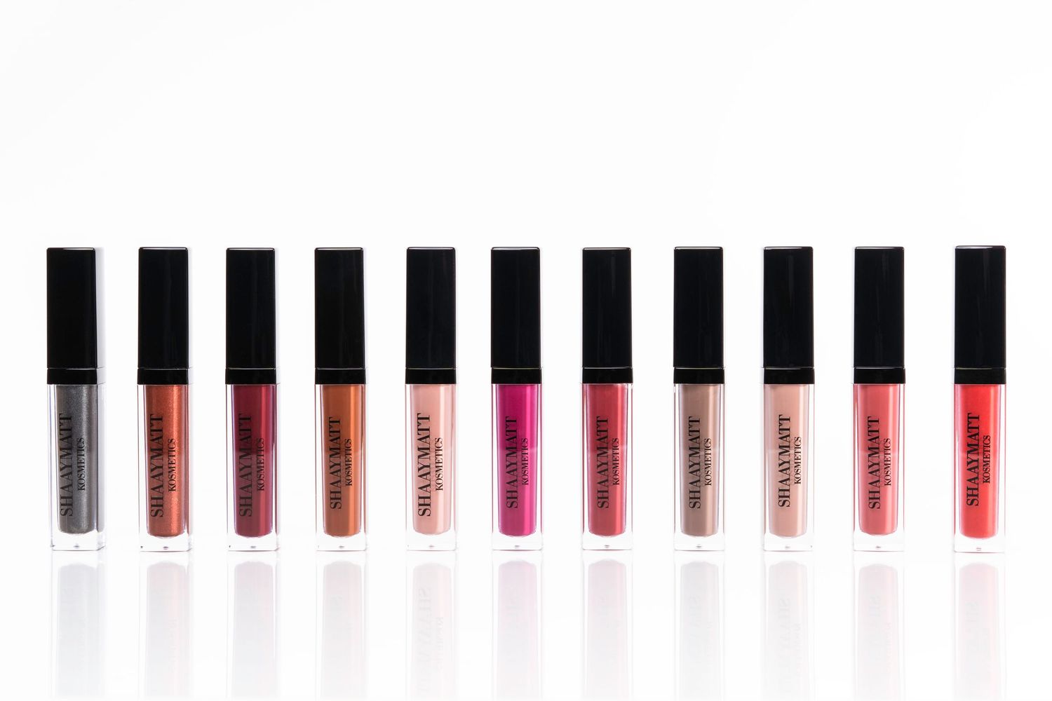 Collection of makeup products arranged in a straight line showing color gradient.
