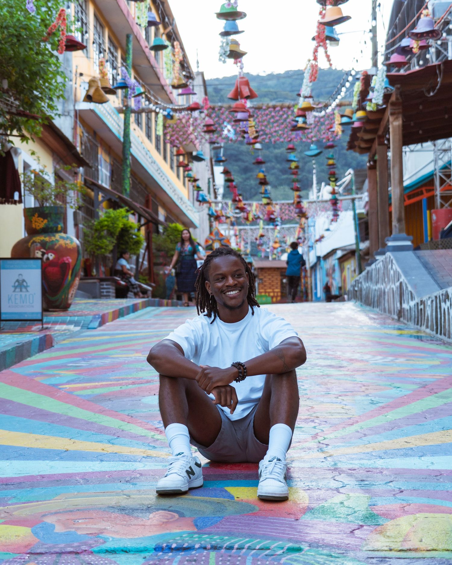 Colorful painted street decorated with hanging lanterns and festive decorations in an urban setting.