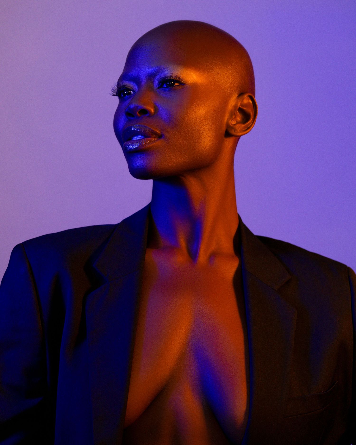 Dramatic portrait series lit with purple lighting creating artistic shadows.