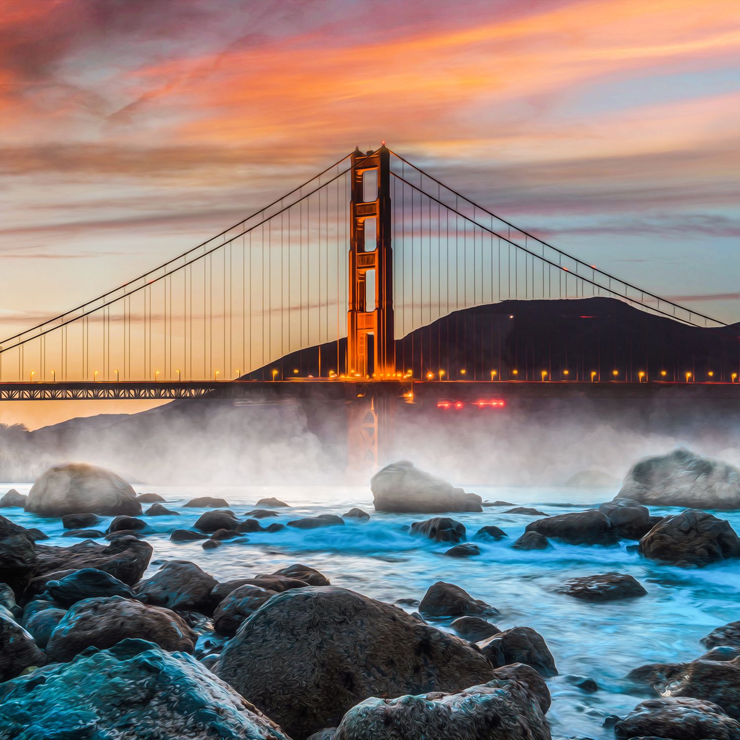 Golden Gate Bridge glowing at sunset with dramatic orange sky and misty waves crashing over rocks in San Francisco.