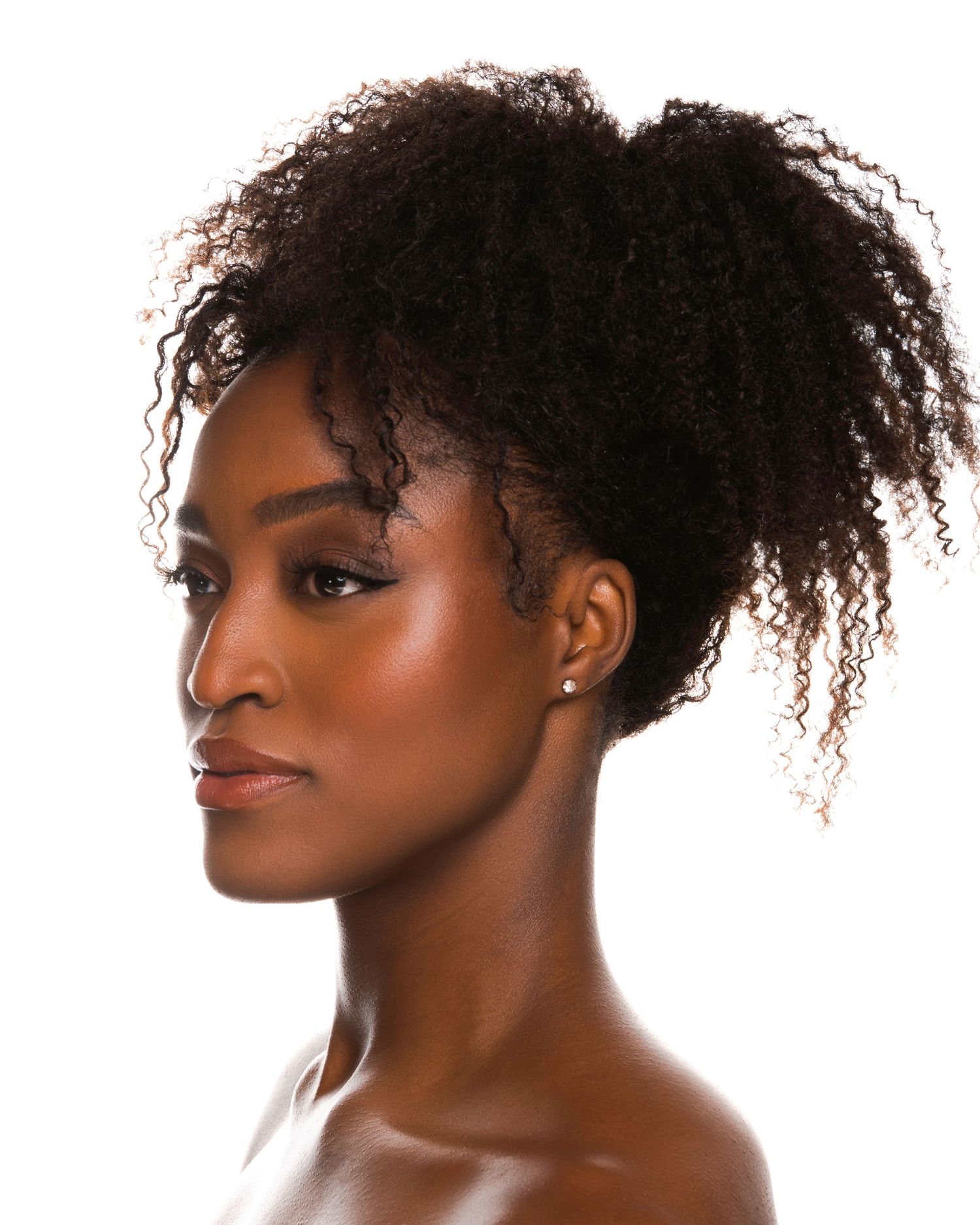 Professional beauty portrait series showing natural curly hair and glowing skin against white background.