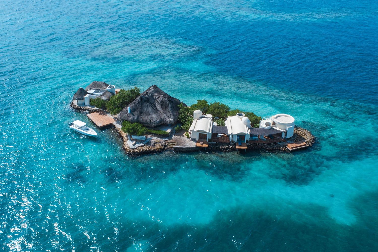 Panoramic view of a rocky coastline with turquoise waters and coral reefs.