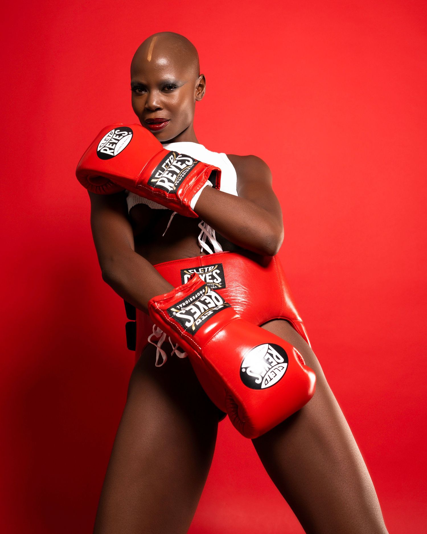 Dynamic poses with red boxing gloves against bright red backdrop showing strength and movement.