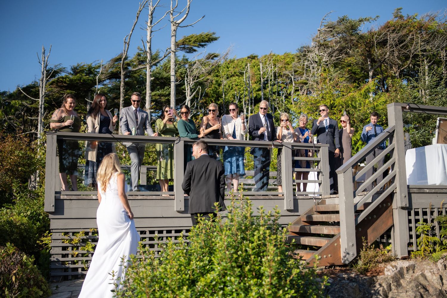 Wedding ceremony setup on coastal boardwalk with ocean views.