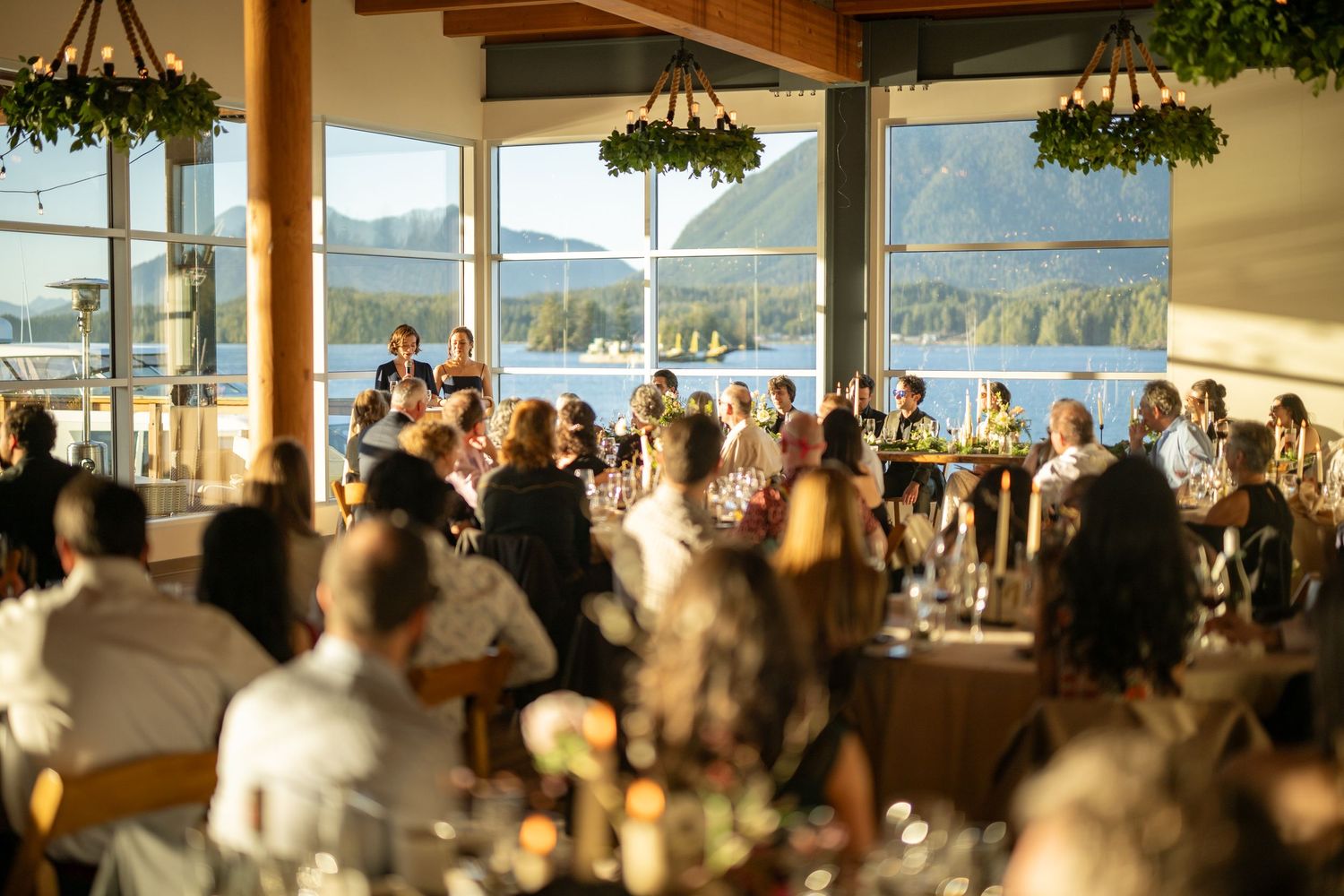 Spacious reception venue with mountain views and natural lighting through large windows.