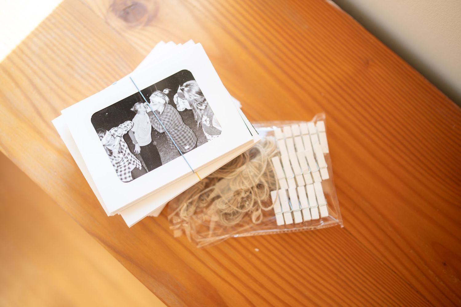 Vintage photographs displayed on wooden surface in warm lighting.