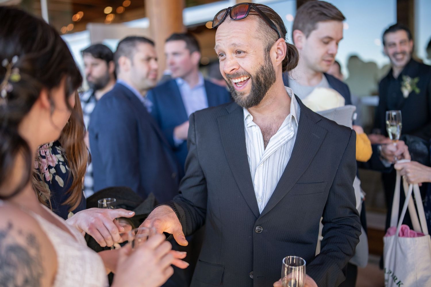 Wedding guests mingling and socializing at an elegant indoor reception.