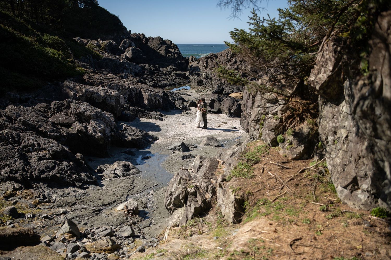 Natural stone pathway leading through coastal cliffs with ocean views.