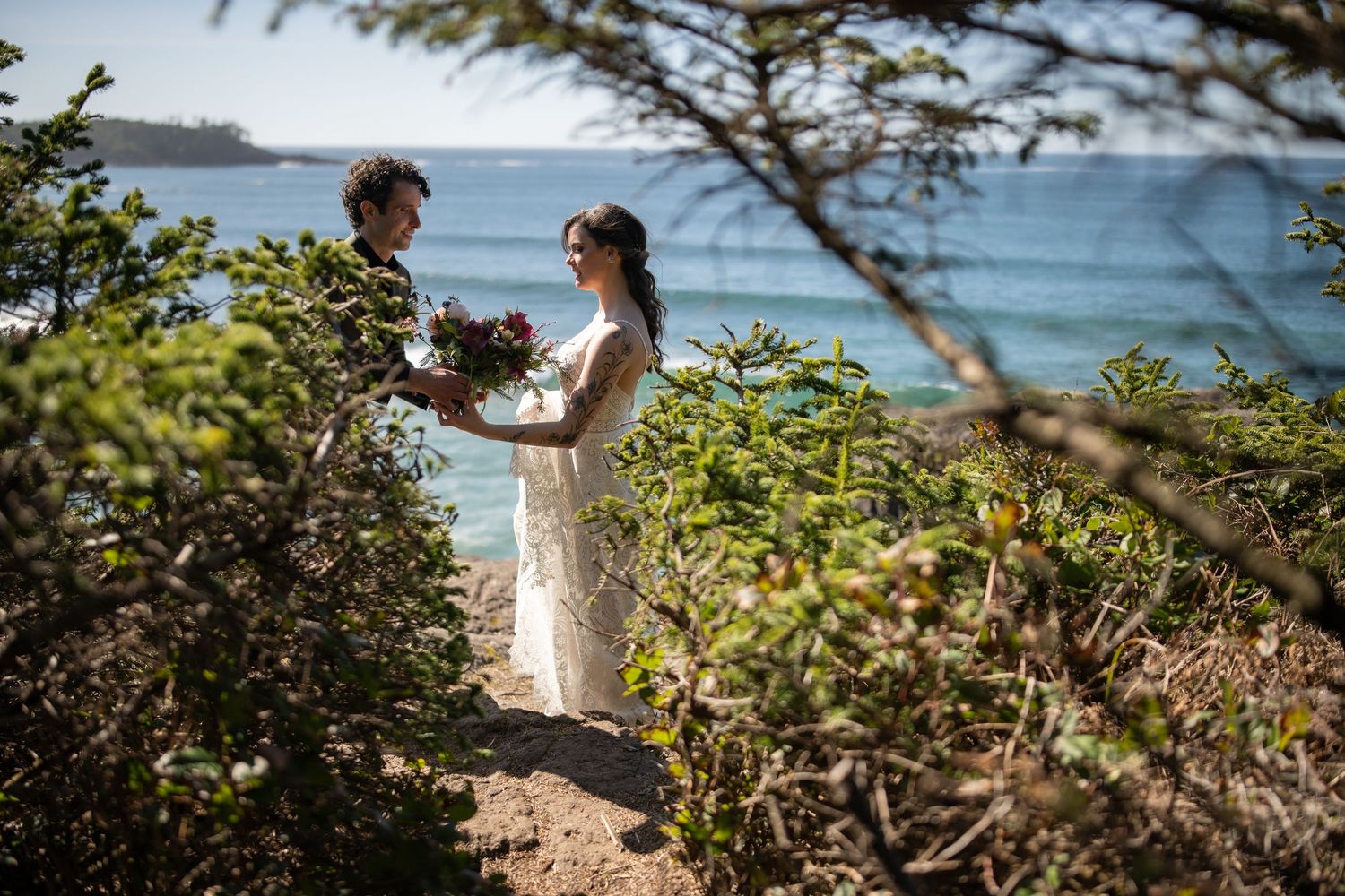 Scenic coastal wedding ceremony location with rocky cliffs and ocean views on a sunny day.