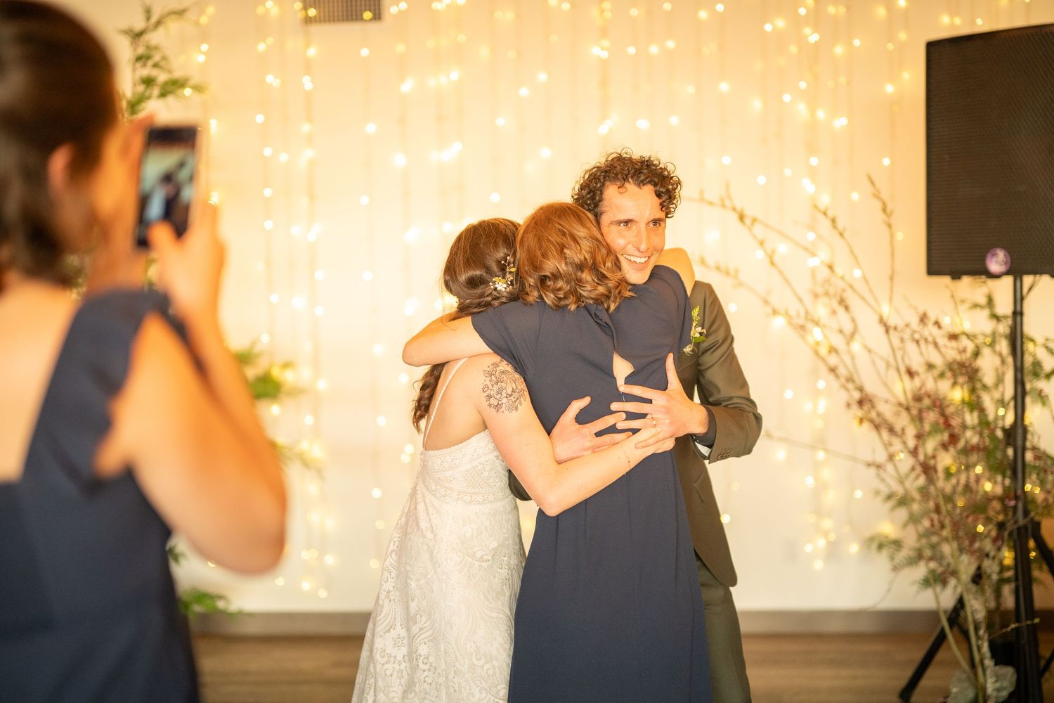 Wedding celebration with string lights creating magical atmosphere during evening reception.
