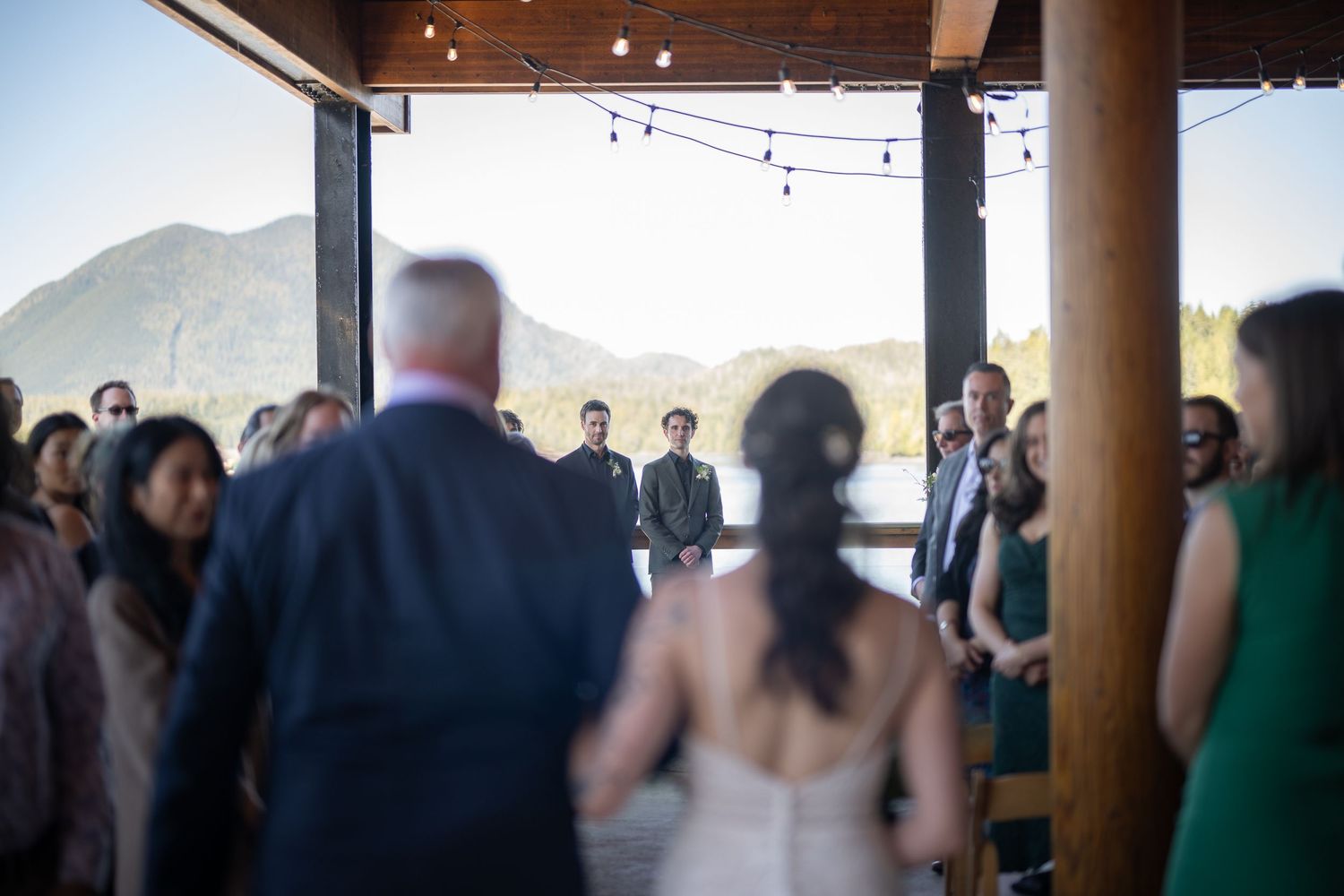 Wedding ceremony in progress at a mountain lodge with panoramic views.