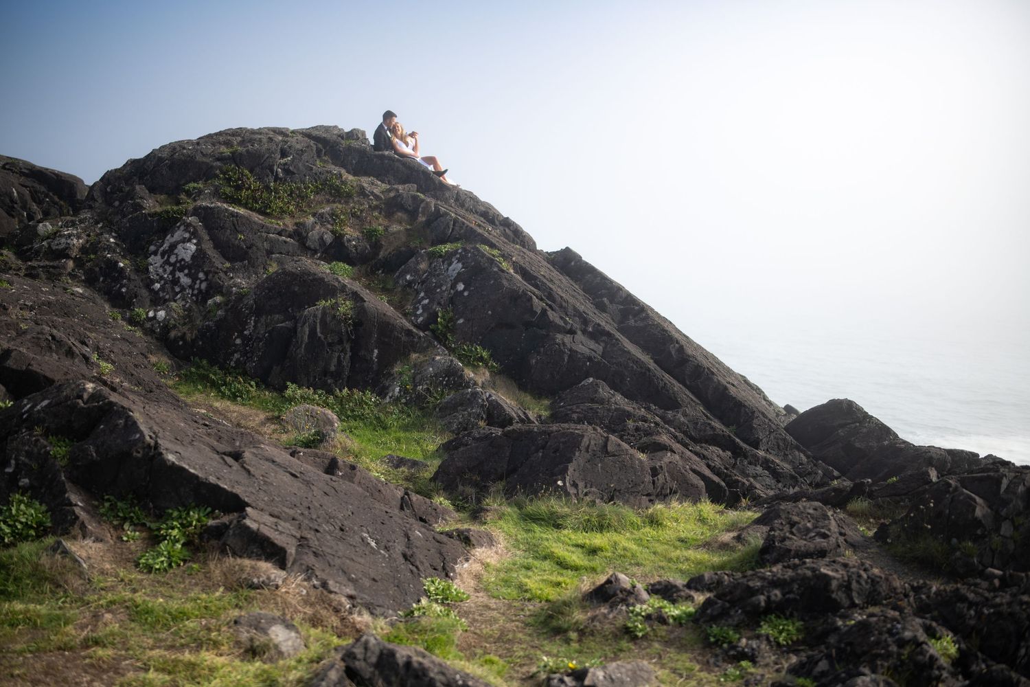 Dramatic rocky coastal landscape with steep cliffs overlooking the ocean.