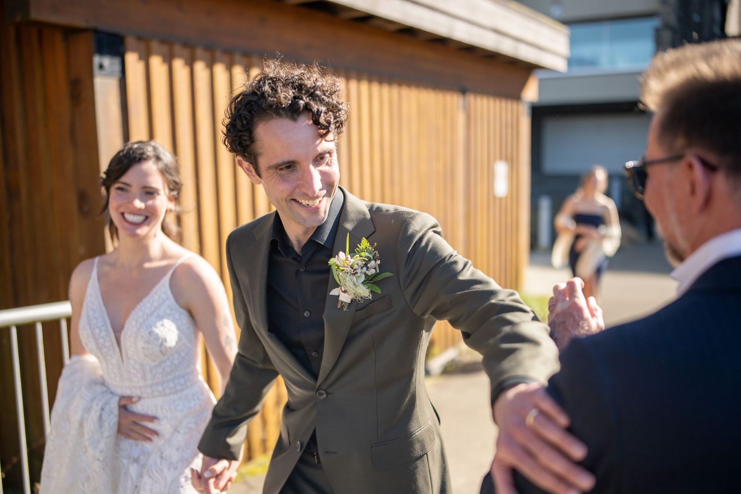 Wedding celebration taking place in a rustic wooden venue with natural lighting.
