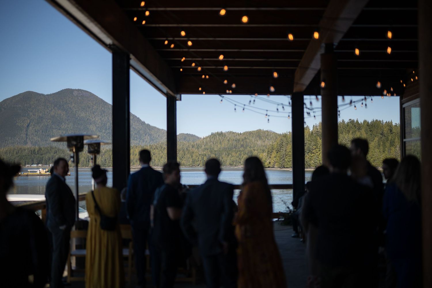 Interior venue space with mountain and water views through large windows.