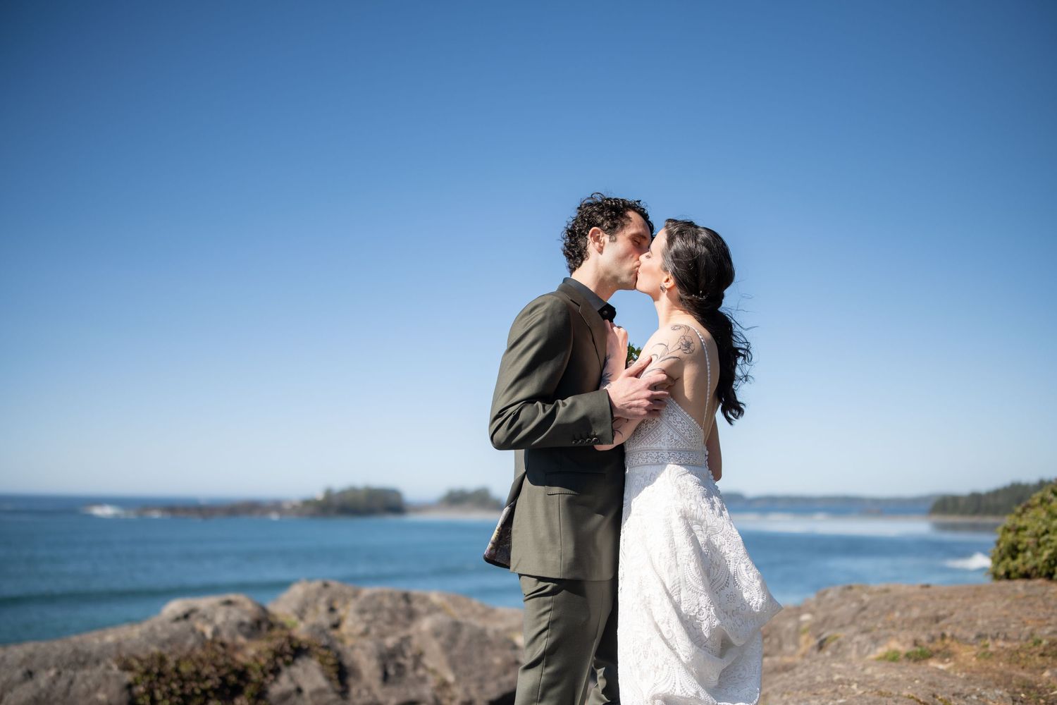 Romantic moment shared on a scenic coastal overlook with ocean views.