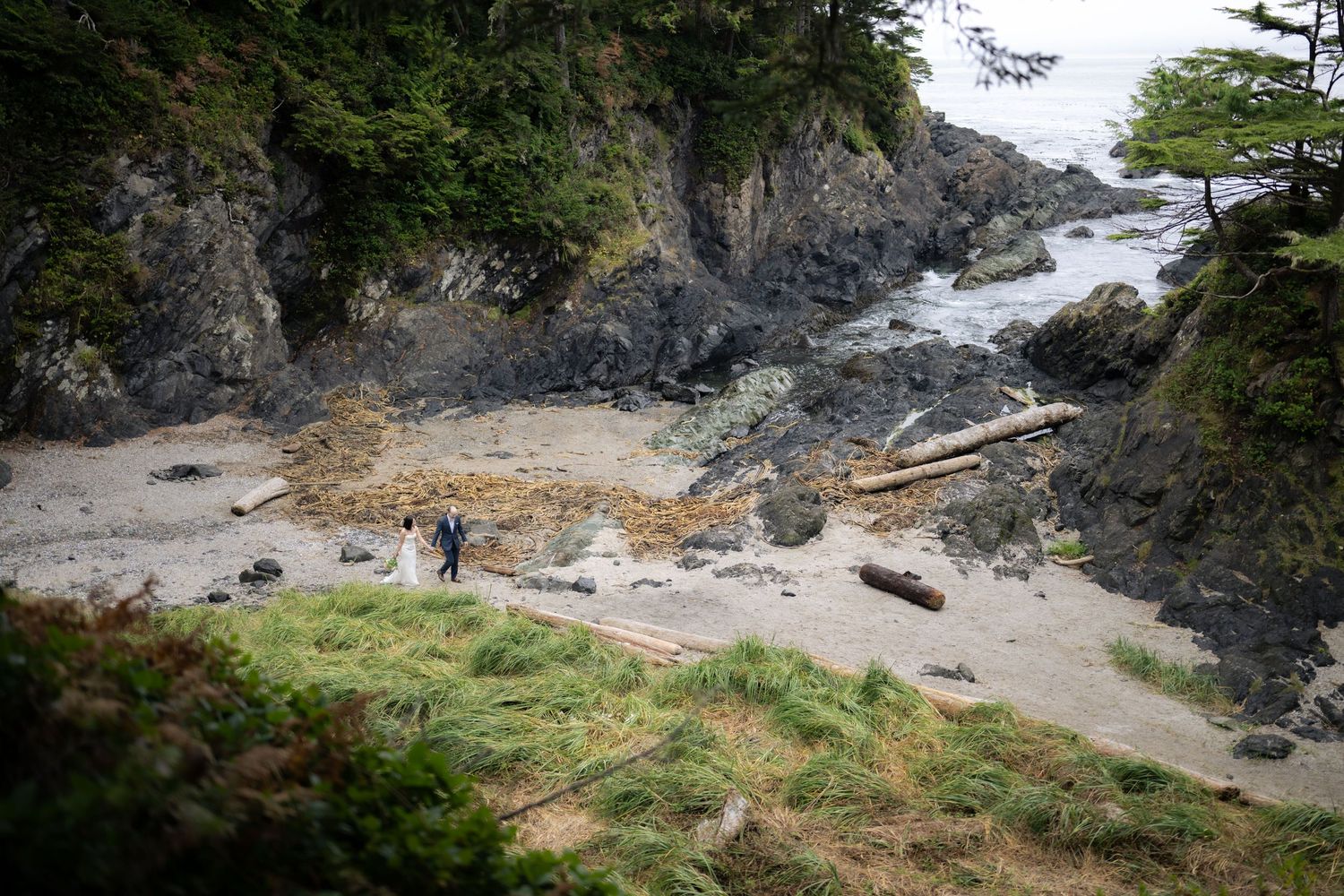 Panoramic view of rocky coastline with cliffs and beach cove.