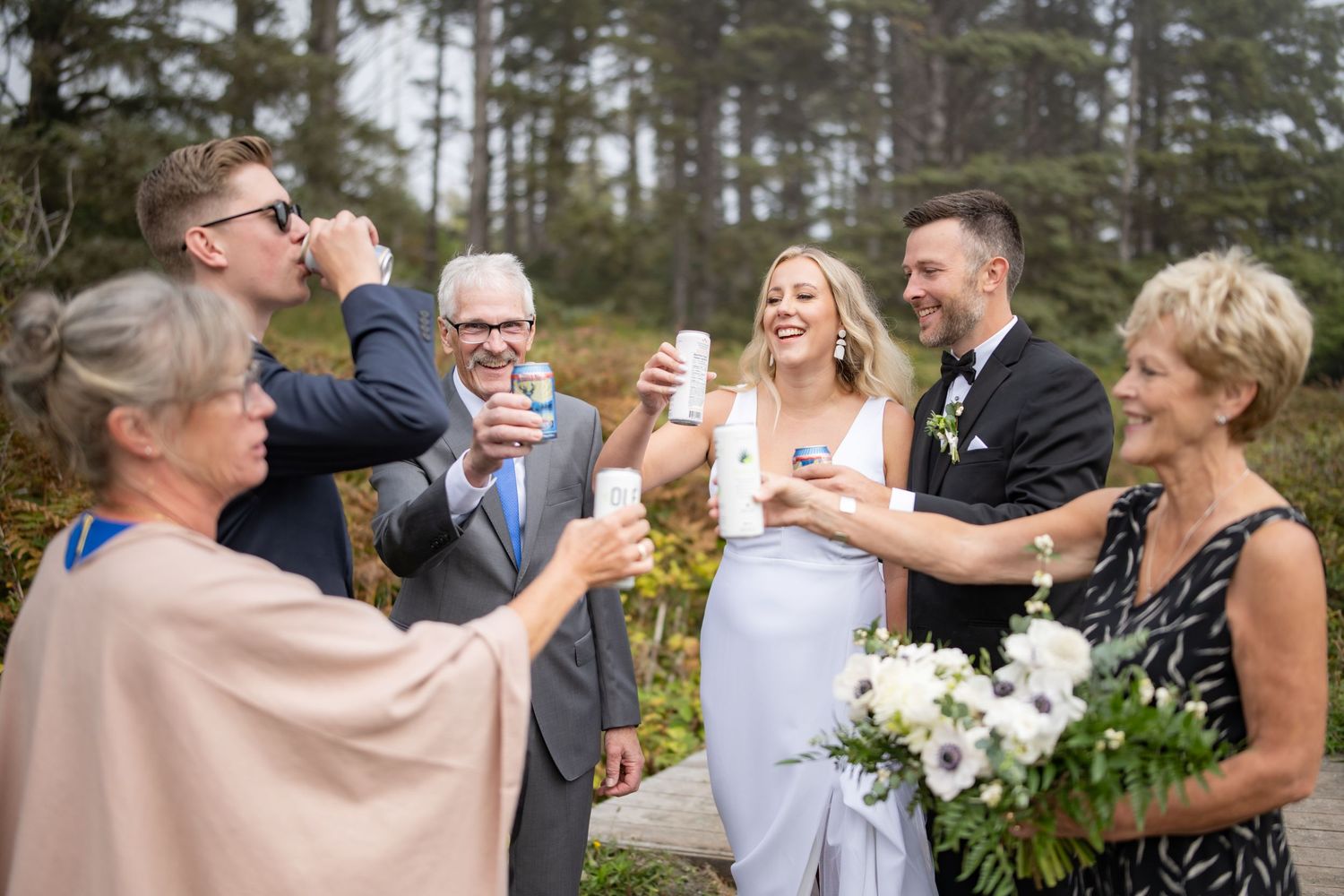 Wedding celebration candid moments with guests on outdoor trail.