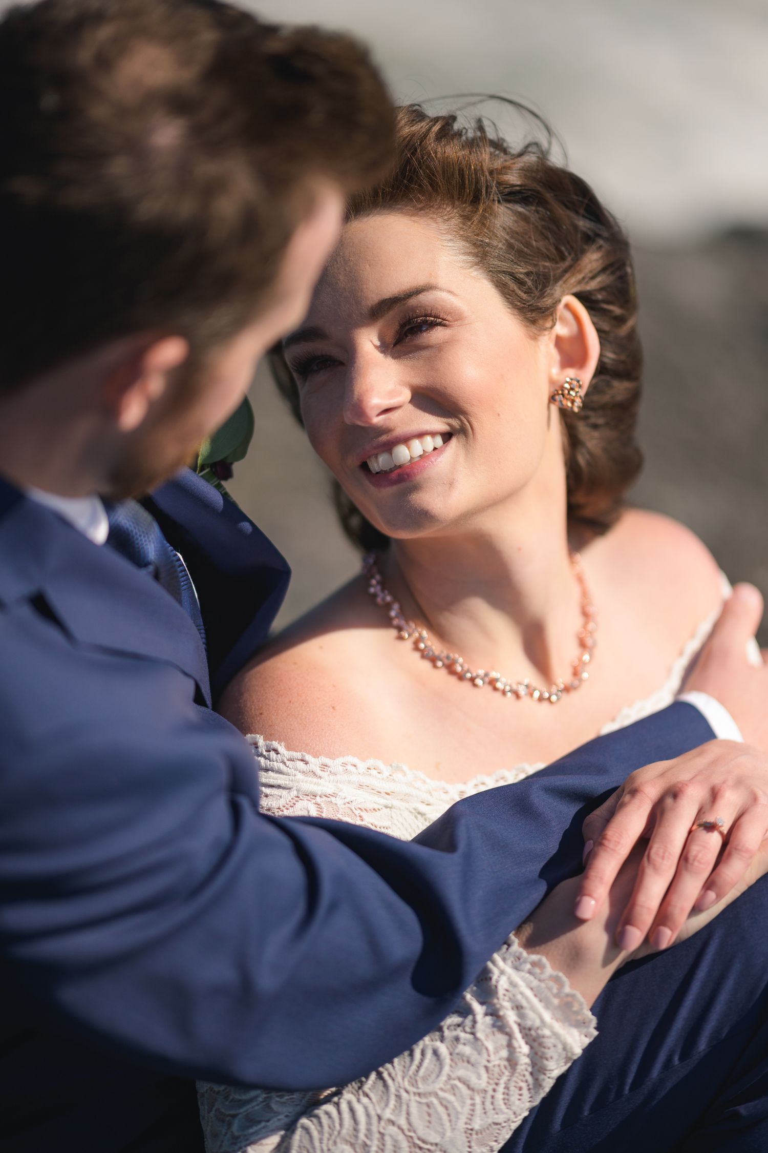 Close-up wedding portrait showing delicate lace details and jewelry.