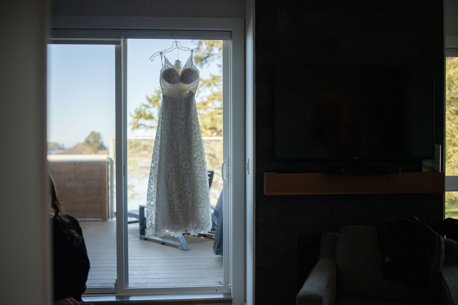 Window view with natural light streaming in and clothing hanging nearby.