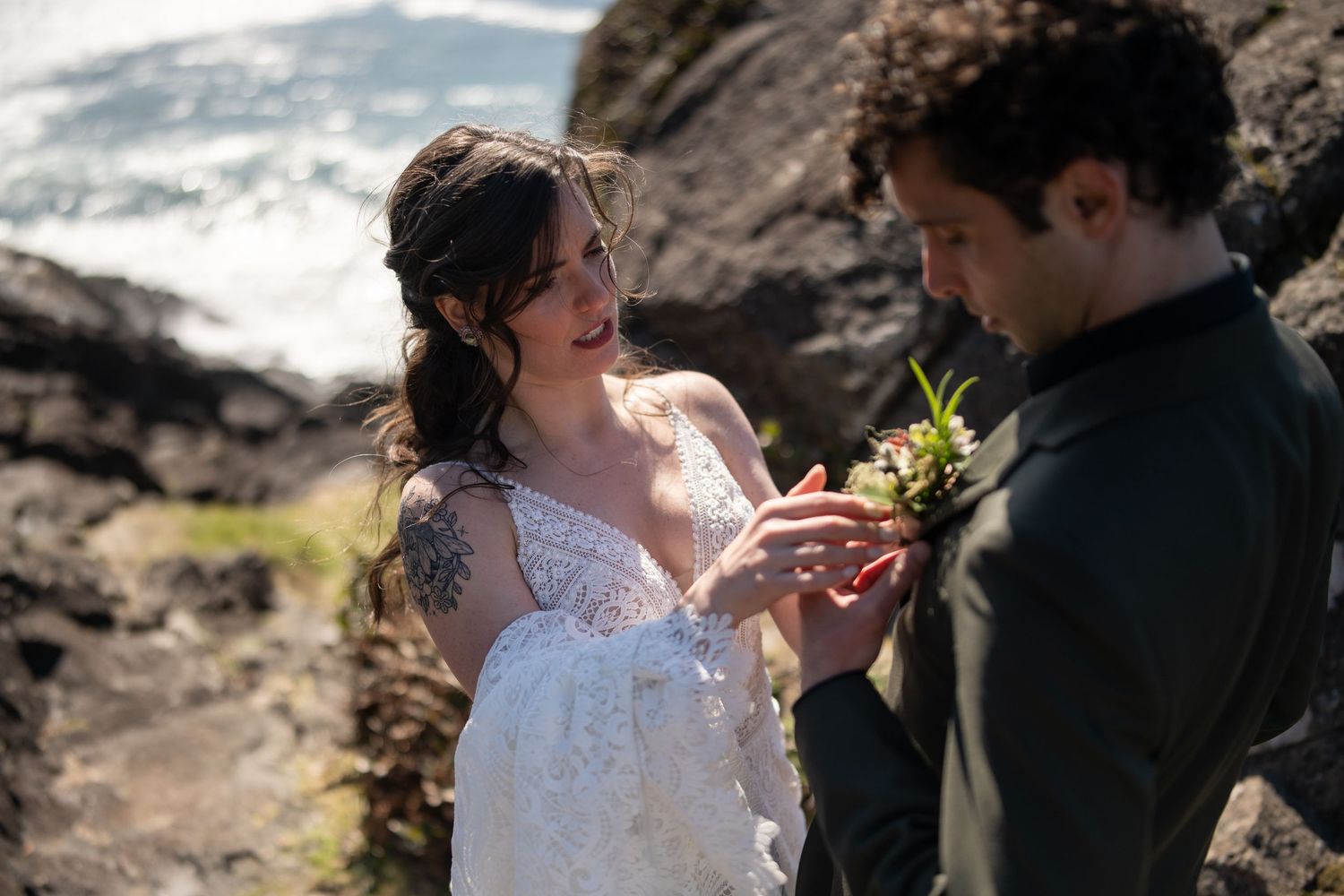 Tender wedding moment shared on dramatic Pacific Northwest shoreline.