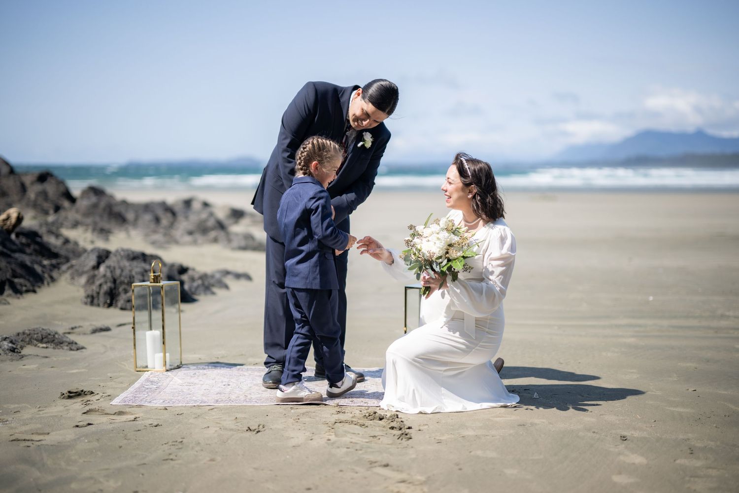 A beach wedding ceremony setup with lanterns and natural coastal elements.
