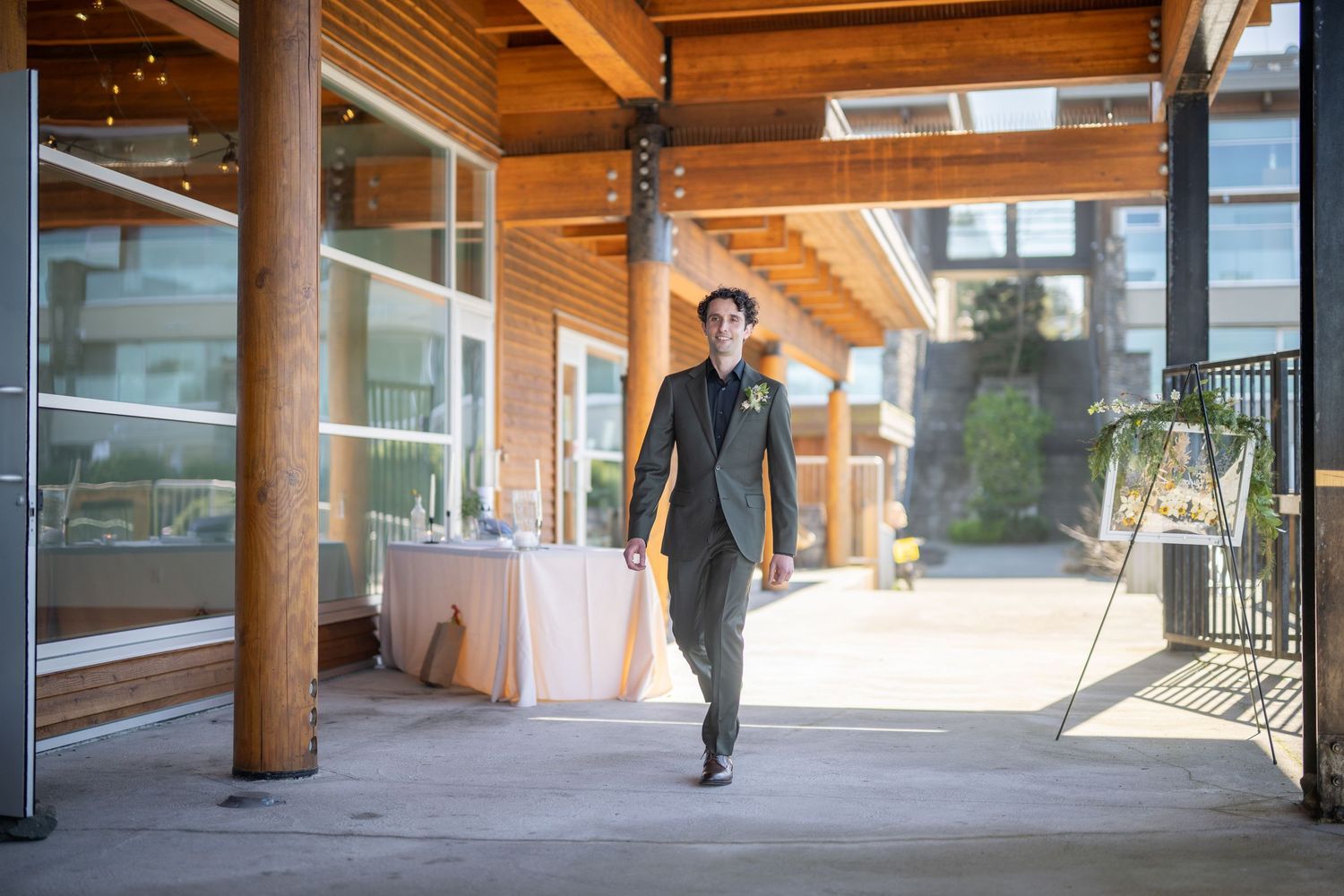 Modern venue interior with wooden beams and large windows overlooking mountain landscape.