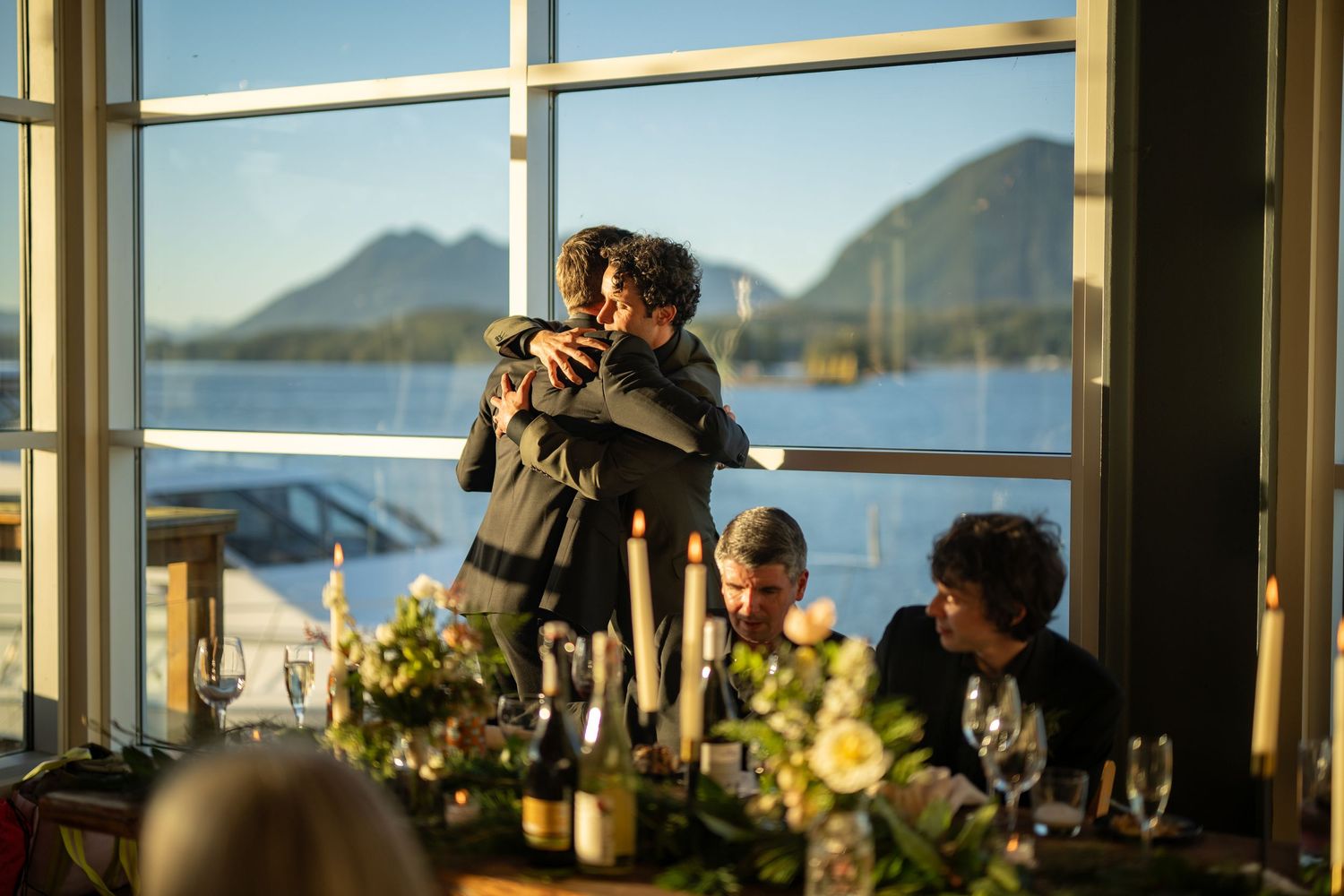 Panoramic mountain and ocean views through floor-to-ceiling windows at an elegant event venue.