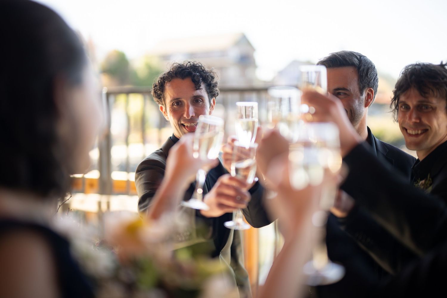 Wedding guests raise glasses in a celebratory toast during the reception.